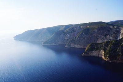 Scenic view of sea and mountains against sky