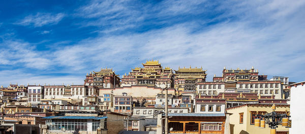 Low angle view of buildings against blue sky