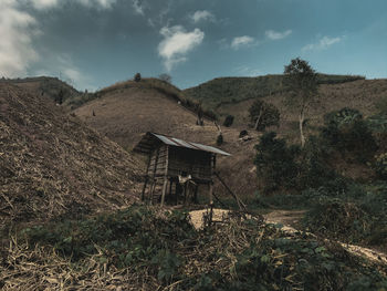 Abandoned house on mountain against sky