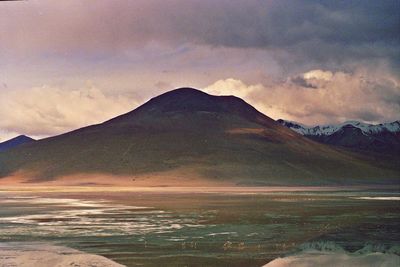 Scenic view of mountains against cloudy sky