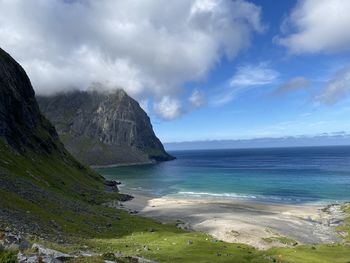 Scenic view of beach, sea and mountain against sky