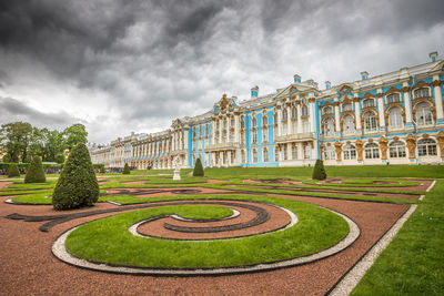 Panoramic view of garden against cloudy sky