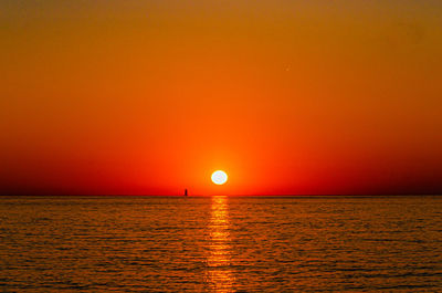 Scenic view of sea against orange sky during sunset