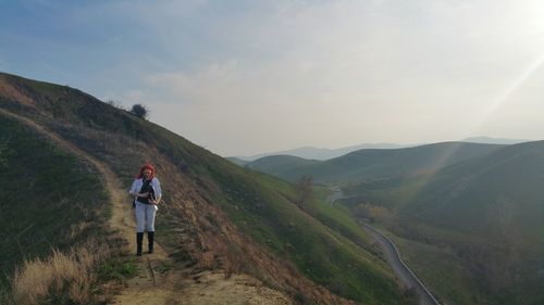 Woman standing on chino hills against sky