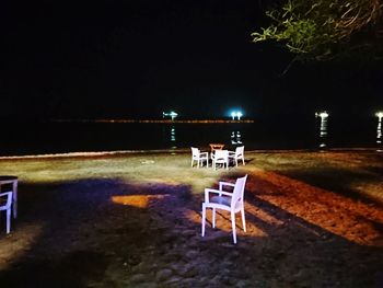 Empty chairs and tables in restaurant at night