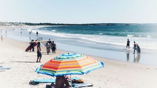 People on beach against sky