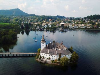 High angle view of townscape by river in city