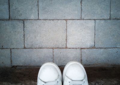 Close-up of shoes on footpath