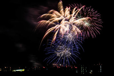 Low angle view of firework display at night