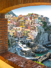 Manarola against sky seen window