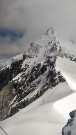 Scenic view of snow covered mountains against sky