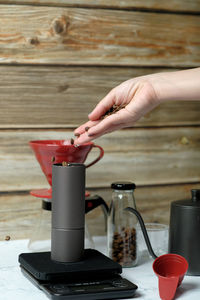 Midsection of person holding coffee cup