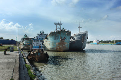 Boat moored in sea against sky
