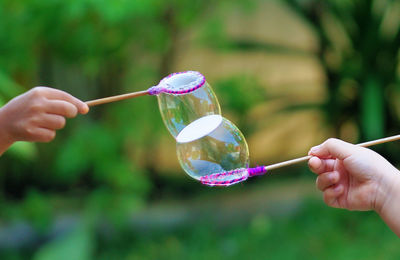 Close-up of hand holding bubble bubbles