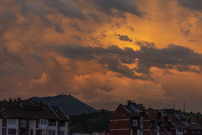 Buildings against sky at sunset