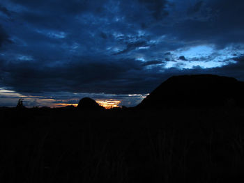 Silhouette of landscape against cloudy sky