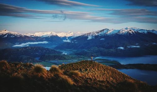 Scenic view of snowcapped mountains against sky at sunset