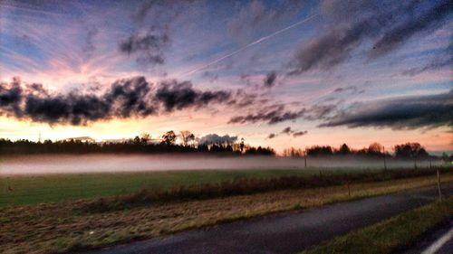 Scenic view of field against sky during sunset