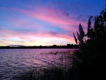 Scenic view of lake against sky during sunset