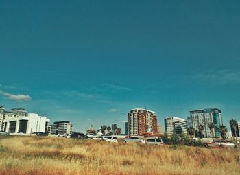 Buildings in city against blue sky