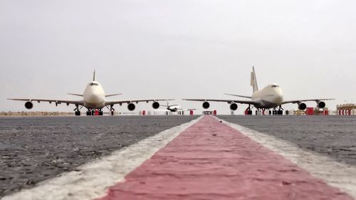 Airplane on runway against clear sky