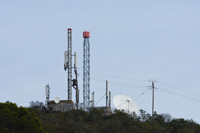 Low angle view of communications tower against sky