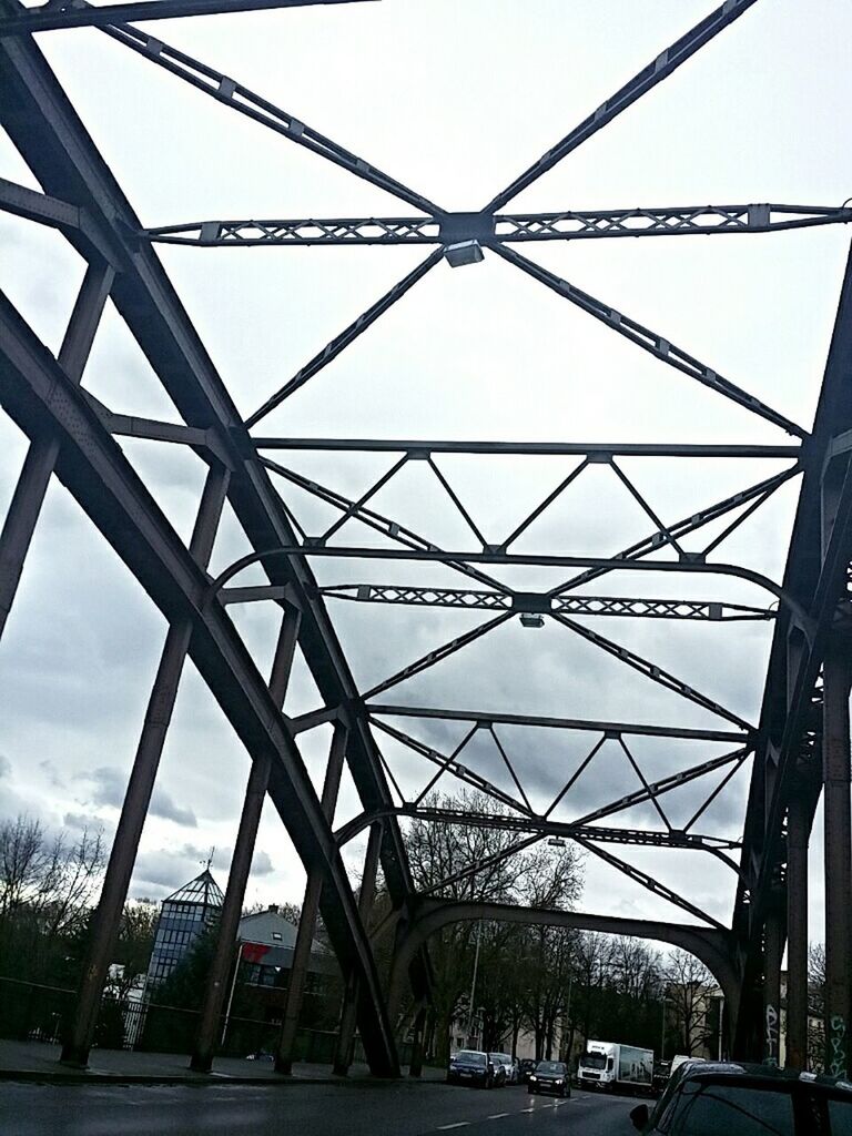 transportation, built structure, car, architecture, land vehicle, connection, mode of transport, bridge - man made structure, engineering, sky, road, diminishing perspective, city, the way forward, street, building exterior, low angle view, bridge, travel, day