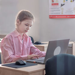 Young businesswoman using laptop at office