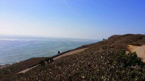 Scenic view of sea against clear blue sky