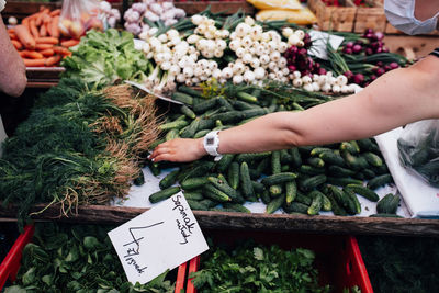 Midsection of woman for sale at market stall