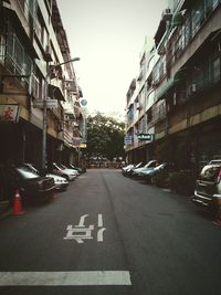 Vehicles on road along buildings