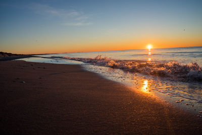 Scenic view of beach against sky during sunset