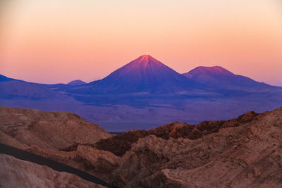 Scenic view of mountain range against sky during sunset