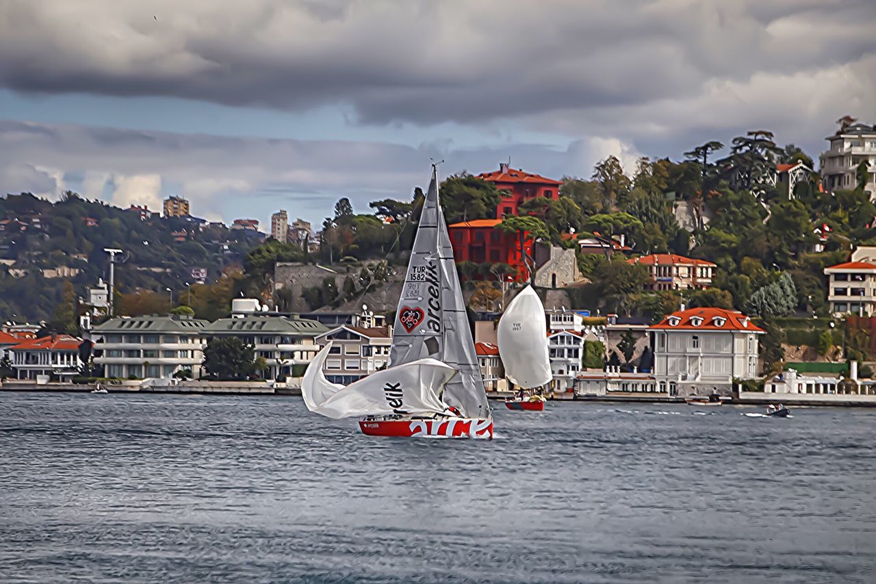 water, waterfront, cloud - sky, building exterior, sky, architecture, nautical vessel, built structure, city, cloudy, sailboat, river, cloud, travel destinations, sea, amusement park, storm cloud, tourism, town, sailing, day, cloudscape, riverbank, outdoors, dramatic sky, ship