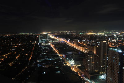 High angle view of illuminated city buildings at night