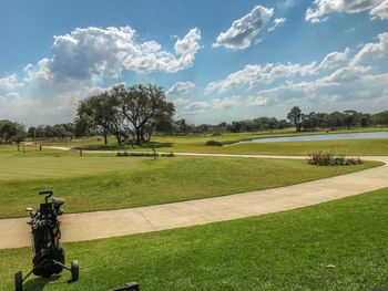 Scenic view of golf course against sky