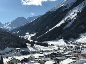 Aerial view of snowcapped mountains against sky