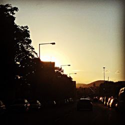 Traffic on road at sunset