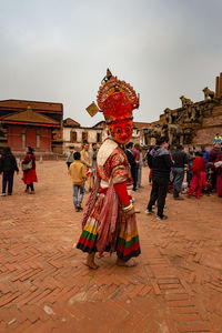 People walking in temple against sky