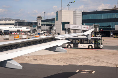 View of airplane at airport runway against sky