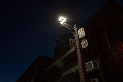 Low angle view of illuminated street light against sky at night