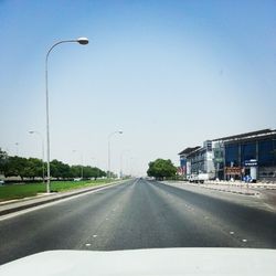 Empty road against blue sky