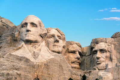 Low angle view of statues at mount rushmore national memorial against sky