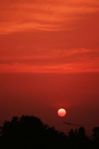 Silhouette trees against romantic sky at sunset