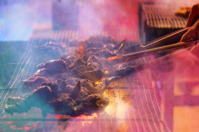 Digital composite image of people on barbecue grill
