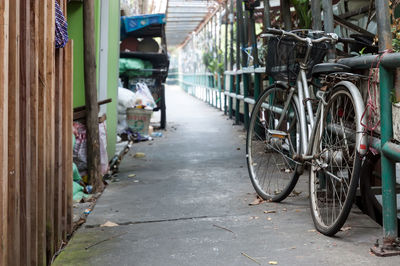 Bicycle parked on footpath amidst buildings in city