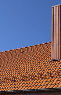 Low angle view of building against clear blue sky