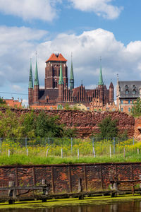 Old building in city against cloudy sky