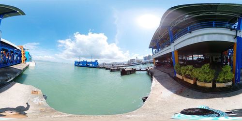 Panoramic view of buildings against cloudy sky