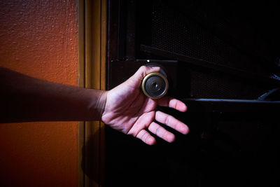 Cropped hand holding doorknob